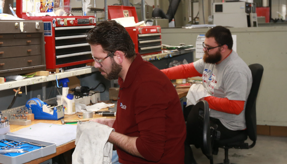 Five Star employees repairing instruments